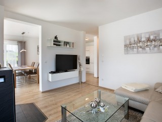 Freunde treffen, quatschen, relaxen: Der offene Wohn-, Ess- und Kochbereich ist das kommunikative Zentrum des Hauses. Wolf – Haus Kugler Wohnbereich